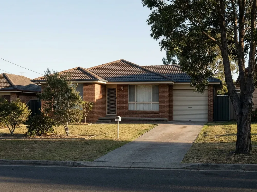 Single-storey brick home with a tiled roof and front lawn